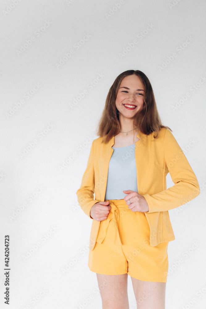 Young stylish happy caucasian woman in yellow suit Young stylish happy caucasian woman in yellow suit