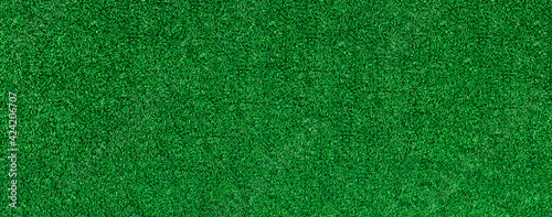 Green artificial grass pattern texture background. Grass meadows on football field or golf. Top view banner.