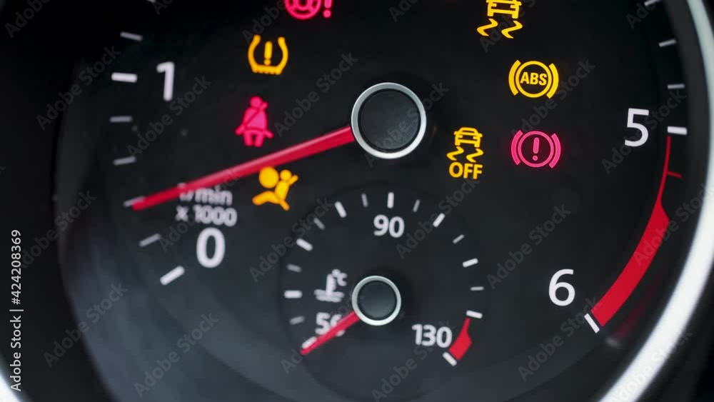 Tachometer Gauge of Starting and Stopping Car. Starting car engine. Dashboard in the car. Many different car dashboard lights with warning lamps illuminated Tachometer Gauge of Starting and Stopping Car. Starting car engine. Dashboard in the car. Many different car dashboard lights with warning lamps illuminated