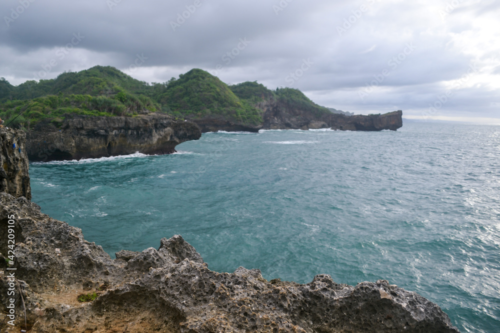 The ocean, rocks and cliff at Gunung Kidul Regency, Yogyakarta, Indonesia. The ocean, rocks and cliff at Gunung Kidul Regency, Yogyakarta, Indonesia.
