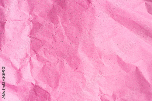 Crumpled pink paper texture. Trendy pink or rose color and surface for text and design