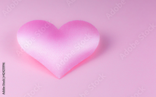 Pink heart on pink background. Saint Valentine's day concept. Love and romantic photo. Postcard for holiday. Beautiful warm wallpaper with love. Soft focus. Copy space.