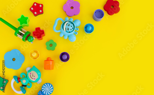 Children's toys frame on a bright yellow background aCopy space for text photo