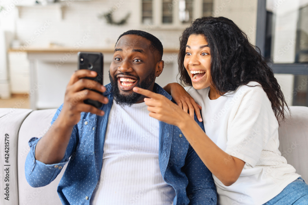 No Way Surprised Multiracial Couple Looks At The Smartphone Screen With Astonishment African