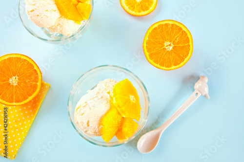 Homemade fresh orange ice cream with orange slices. Summer dessert.