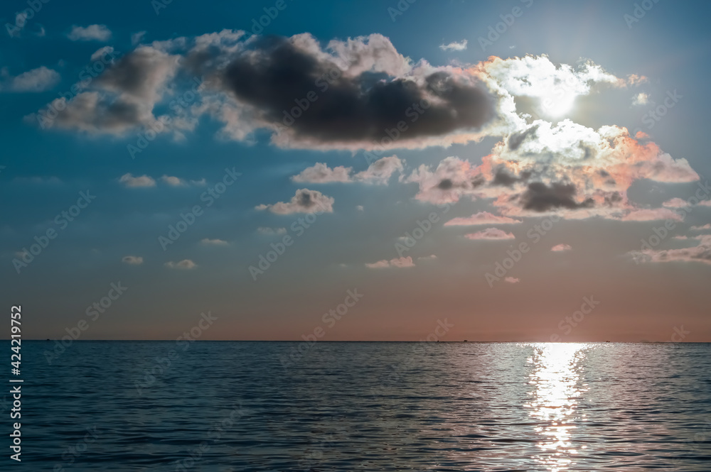 Beautiful sunset on the calm sea with cloudy sky