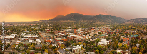 aerial sunset panorama through smoke and clouds of Boulder cityscape and mountain landscape