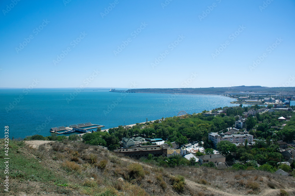 A picturesque bay in Kerch on the Crimean peninsula. On the right, the Crimean bridge is visible in the distance