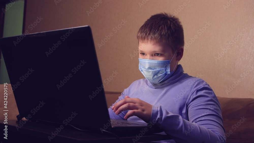 A child learns online from home watching a lesson, listening to the teacher. Video call, isolation training. Conference call on a laptop, chat on a webcam. Distance virtual education concept. A child learns online from home watching a lesson, listening to the teacher. Video call, isolation training. Conference call on a laptop, chat on a webcam. Distance virtual education concept.