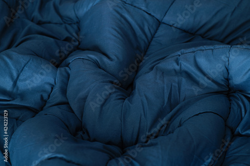 blue blanket spread out on the bed, texture, top view