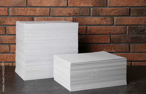 Stacks of paper sheets on black table