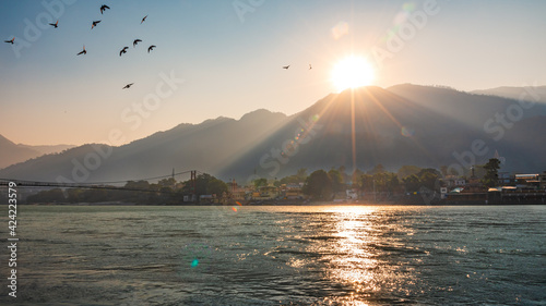 Photos Spectacular panoramic cityscape of Rishikesh during sunrise, the yoga capital of World located in foothills Himalayas along banks of river Ganga or Ganges in Uttarakhand state of India