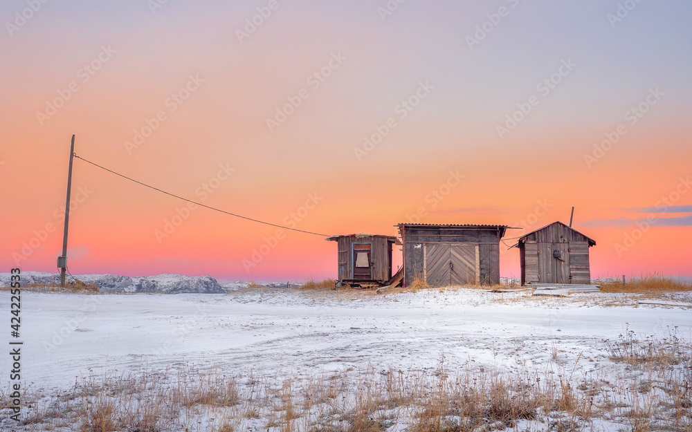 Fototapeta premium Minimalist landscape. Wooden fish smokehouses in authentic village of Teriberka.