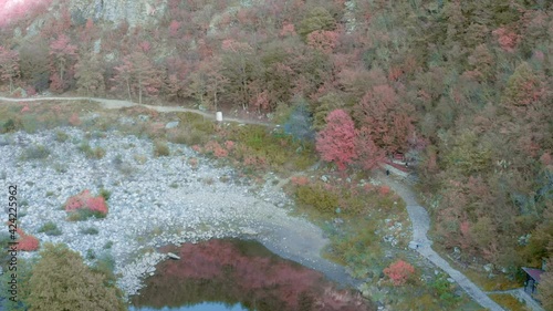 Beautiful ancient stone bridge called Devil's bridge in autumn forest at sunset. Ottoman Architecture near the town of Ardino , Rhodope Mountain and Arda river, Kardzhali Region, Bulgaria. photo