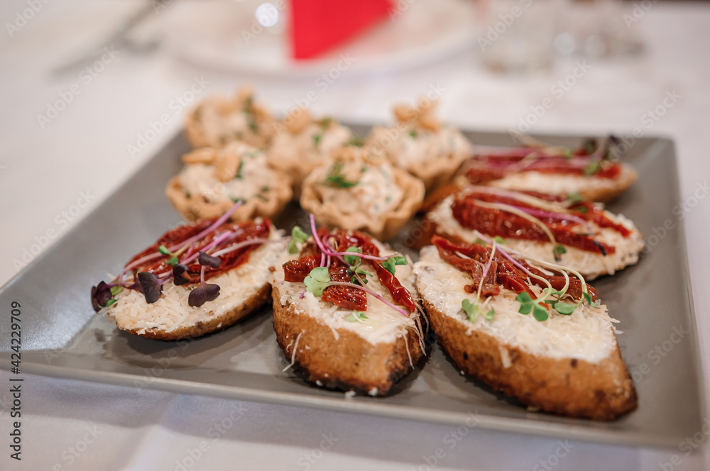Canapes with sun-dried tomatoes and microgreen Canapes with sun-dried tomatoes and microgreen