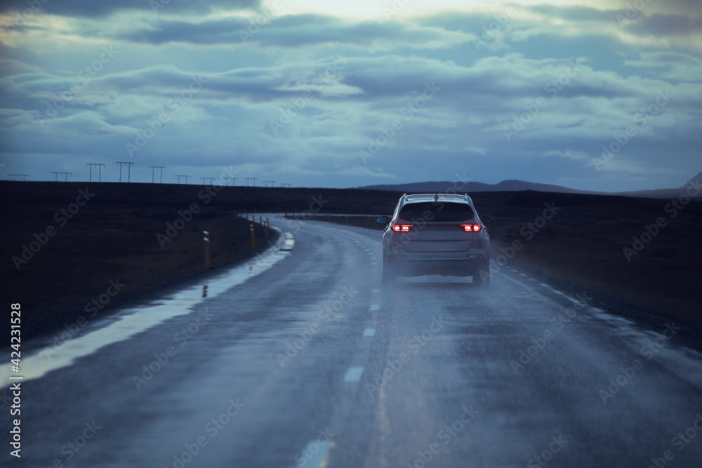 Fototapeta premium Drive car on road. Iceland travel. View from the inside. Beautiful nature icelandic landscape in the dusk