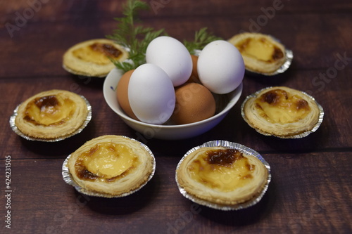 Composition of belem cakes with bowl of eggs
