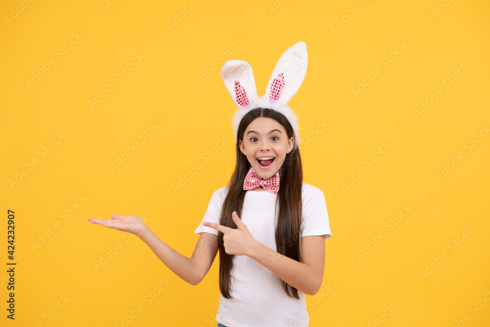 surprised kid girl presenting product or shopping sales, copy space, easter sale.
