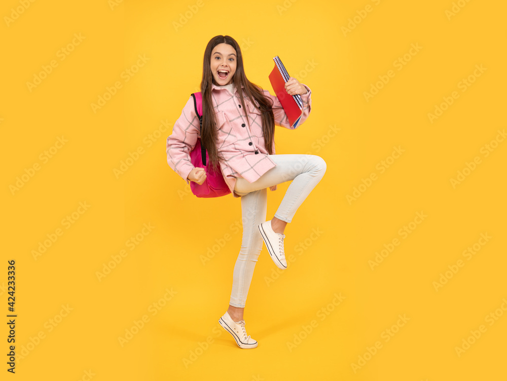 tween child carry school bag. childhood and education. energetic student hold notebooks running tween child carry school bag. childhood and education. energetic student hold notebooks running