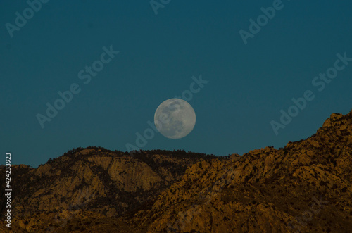 full moon over the mountains