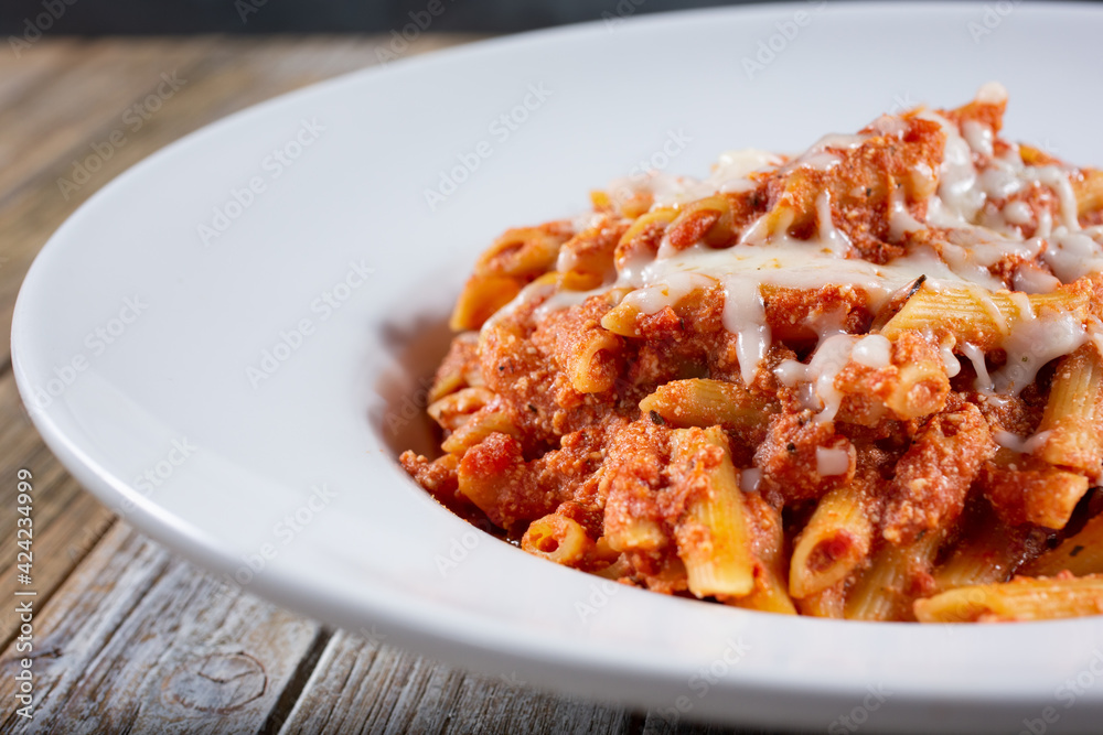 A view of a plate of baked ziti. A view of a plate of baked ziti.