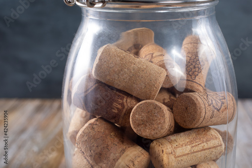 A view of many wine corks inside a glass jar.
