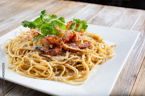 A view of a plate of Asian seafood spaghetti.
