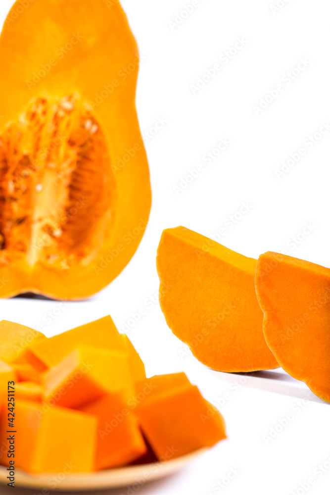 Orange cutted pumpkin pieces. Sliced pumpkin isolated on a white.