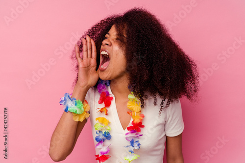 Young african american woman wearing a hawaiian stuff shouting and holding palm near opened mouth.