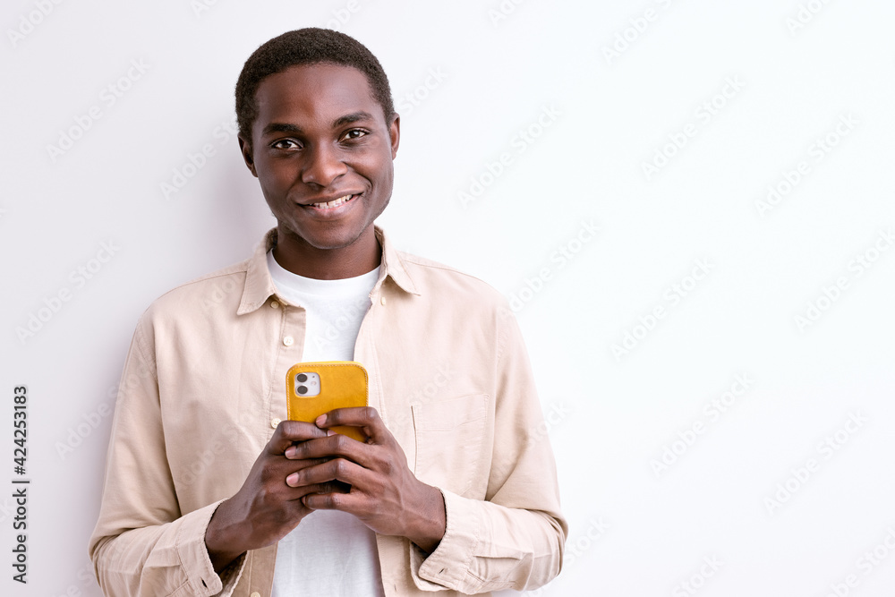 nice young afro man holding mobile phone in hands creating social strategy influencer thinking nice young afro man holding mobile phone in hands creating social strategy influencer thinking