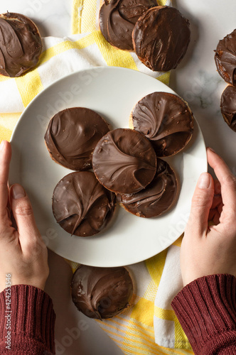 Tagalong cookies, copycat from girl scout's cookies. Made with chocolate and peanut butter on a shortbread cookie. White marble background photo