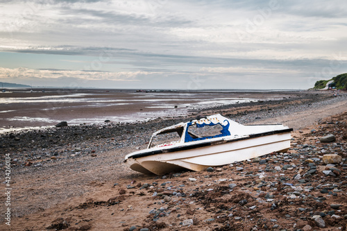 Old rusty boat on Thurstaston beach during low tide photo