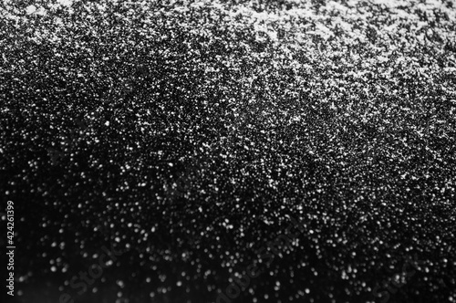 white flour on a black background, texture