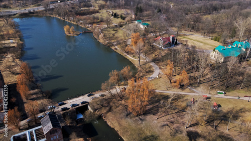 Flight over the city park. Old buildings and the river are visible. Aerial view of the old manor. Loshitsa manor, Minsk, Belarus. Back view. "Loshitsa". Manor XVIII-XIX centuries