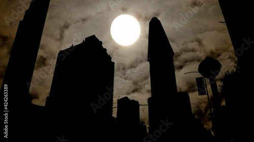 Flat Iron building by Night, Time Lapse with Full Moon, Fog and Dark Atmosphere, New York City, USA