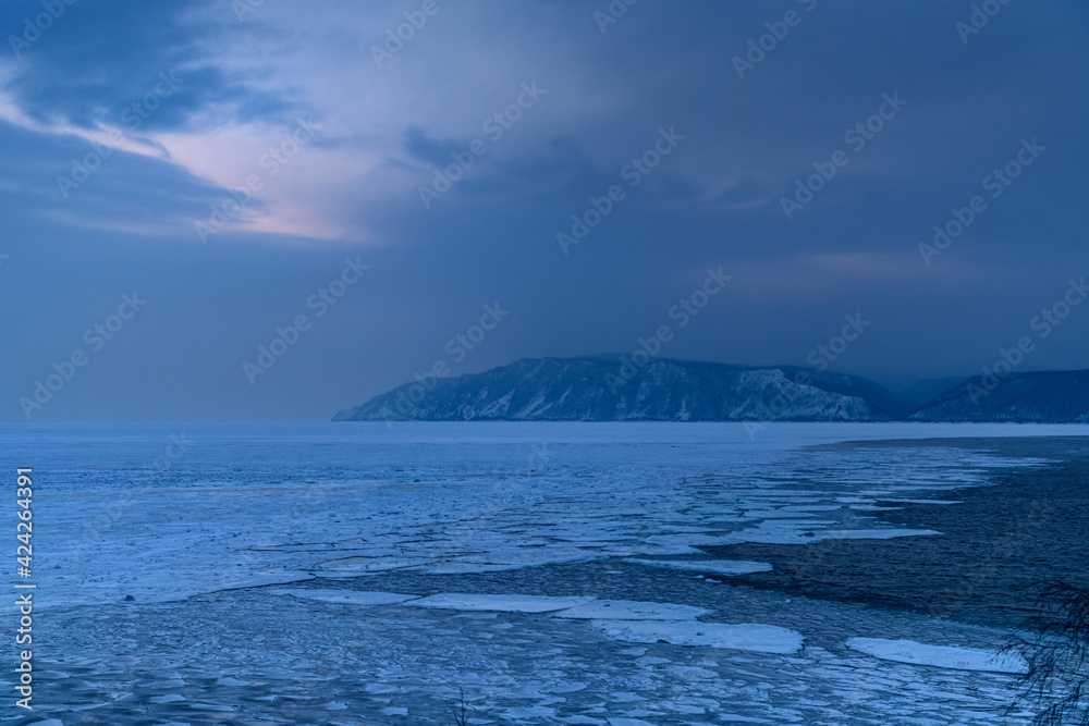 Sourse of the Angara from Baikal lake in tne evening in winter. Listvyanka, Irkutsk Region, Russia Sourse of the Angara from Baikal lake in tne evening in winter. Listvyanka, Irkutsk Region, Russia
