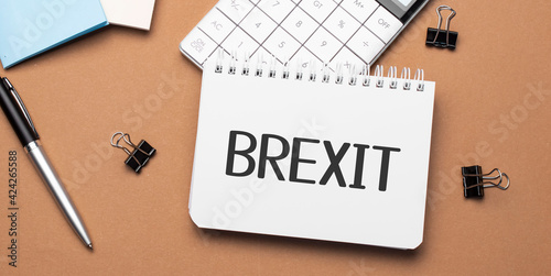 Brexit on notepad with pen, glasses and calculator
