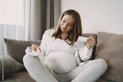 Pregnant woman looks at photo
