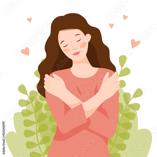 The girl hugs herself by the shoulders. A woman loves her body and takes care of herself. Love yourself concept. Self care.