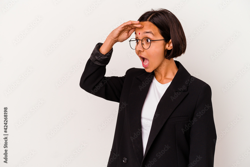Young business Indian woman isolated on white background looking far away keeping hand on forehead. Young business Indian woman isolated on white background looking far away keeping hand on forehead.