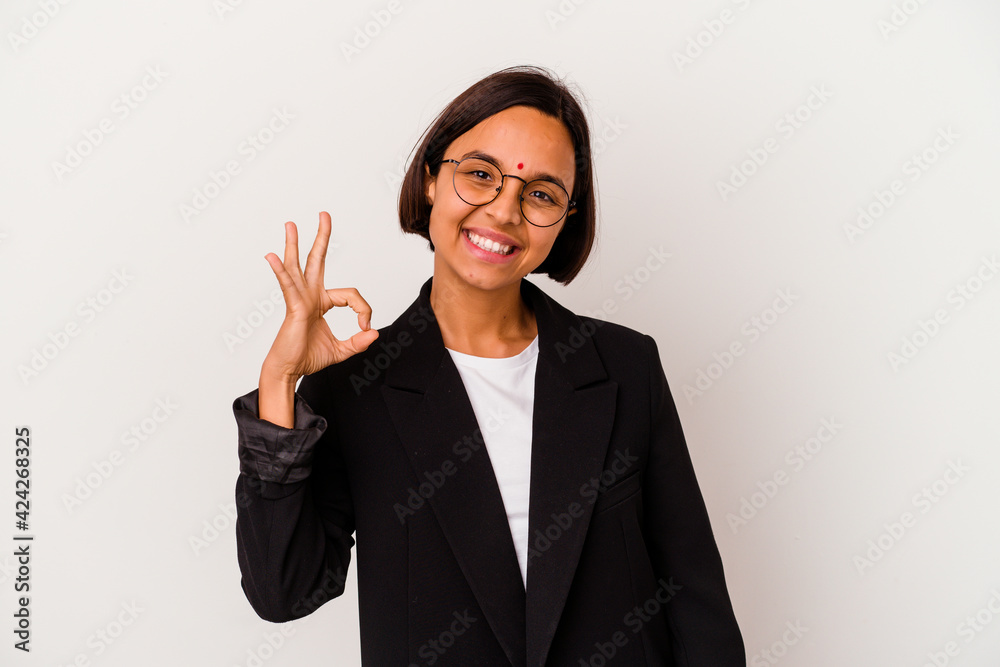 Young business Indian woman isolated on white background cheerful and confident showing ok gesture. Young business Indian woman isolated on white background cheerful and confident showing ok gesture.