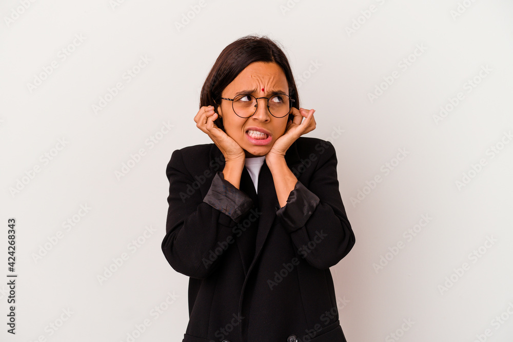 Young business Indian woman isolated on white background covering ears with hands. Young business Indian woman isolated on white background covering ears with hands.