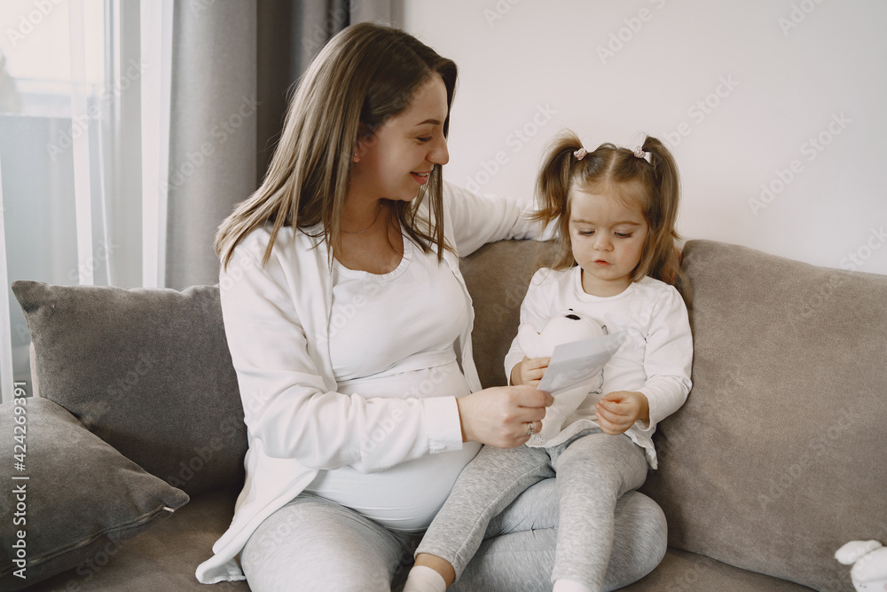 Mom and daughter sitting on couch