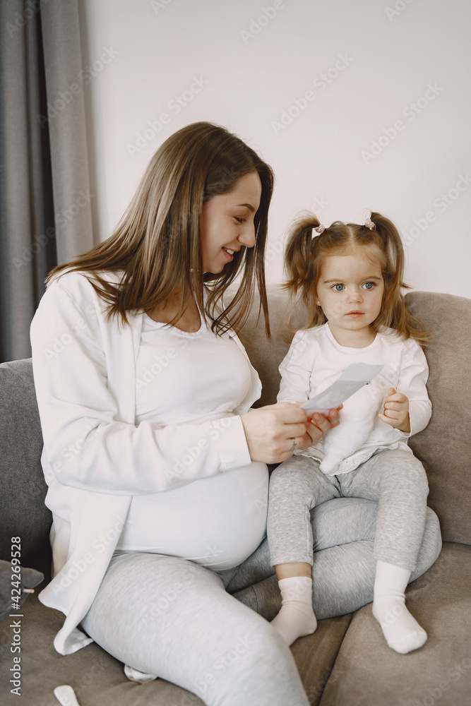 Mom and daughter sitting on couch