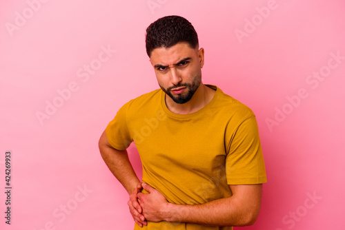 Young mixed race man isolated on pink background