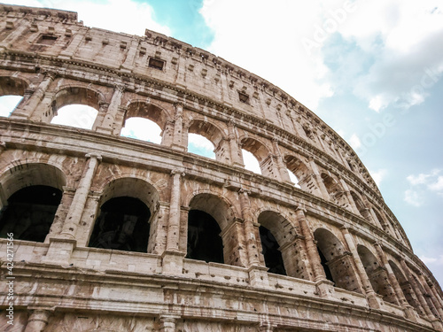 Marble arches ruins of Colosseum outside top part epic view. Iconic ancient monumental 3-tiered Roman amphitheater, gladiatorial games arena in center of Rome, Italy