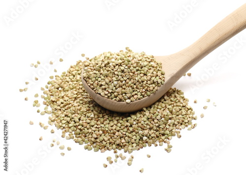 Peeled buckwheat seeds in wooden spoon isolated on white background 