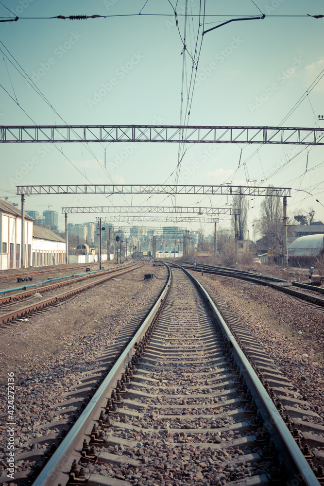 Railway tracks in the city with track bed. Gravel and switch at a railroad crossing.