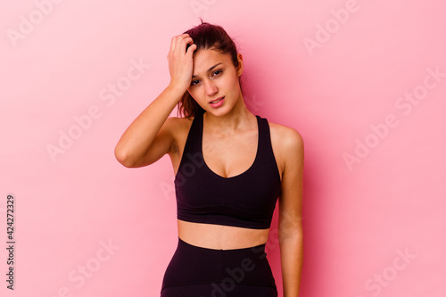Young sport Indian woman isolated on pink background being shocked  she has remembered important meeting.