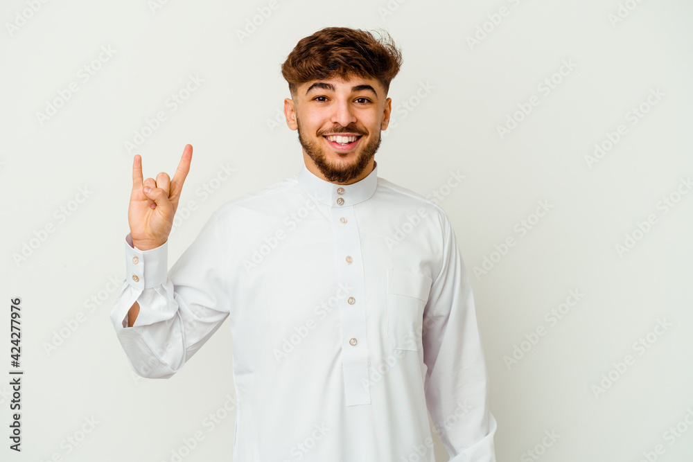 Young Moroccan man wearing a typical arab clothes isolated on white background showing a horns gesture as a revolution concept.